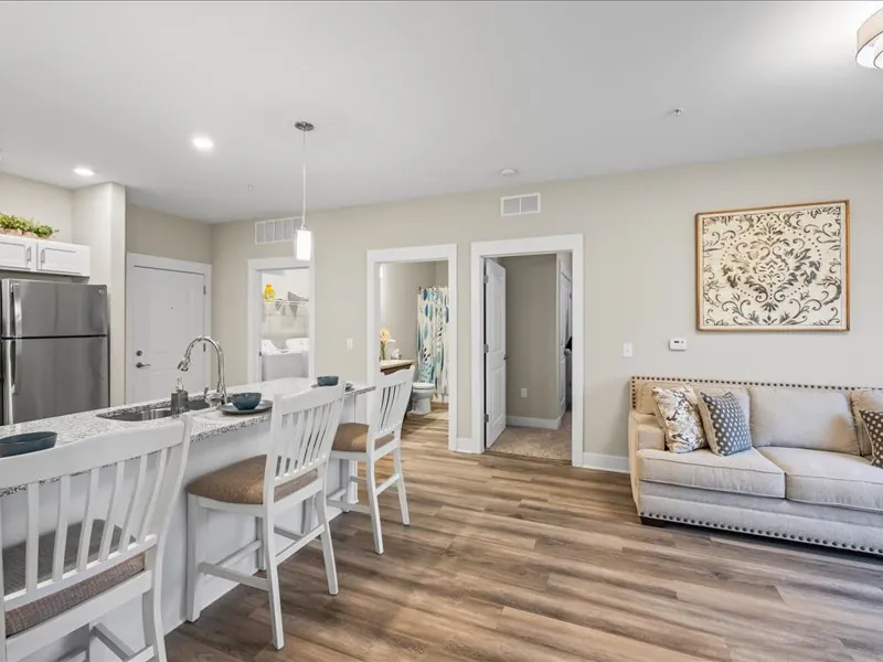A furnished apartment interior at The Bend with an open kitchen