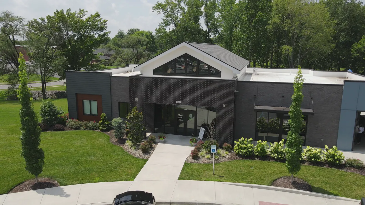 The clubhouse exterior at The Bend with landscaped beds