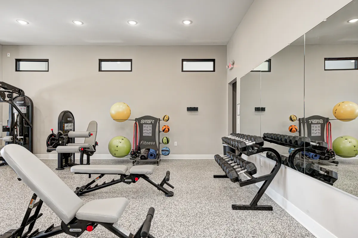 The fitness center at The Bend with cardio and weight equipment